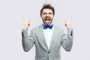 man in a suite making wild gestures and facial expression representing co-worker annoyances