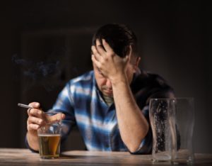 depressed man drinking in a bar for alcohol awareness month