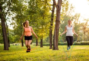 two women jumping rope in the park