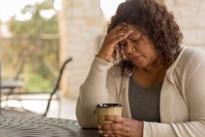 African American woman alone grieving coronavirus-related death