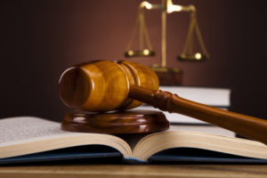 gavel, law book and scales to illustrate concept of employment law