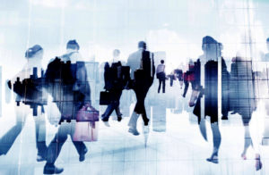 business people rushing in blue sillhouette to signify return to the workplace