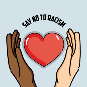 illustration of a black hand and a white hand surrounding a heart with a banner reading "say no to racism" at work