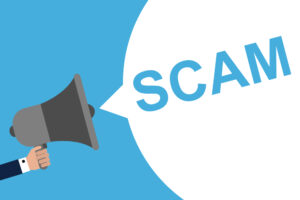 illustration of a hand holding a megaphone with a speech bubble reading "scam"