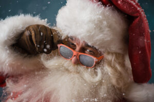 Santa Claus wearing sunglasses. Imaage illustrates a post about his dual roles as employee and employer.