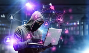 cyber criminal using a laptop to engage in AI-driven scams